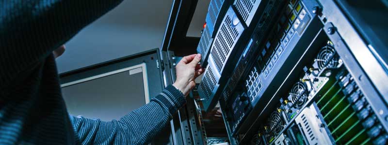 An engineer racking a server