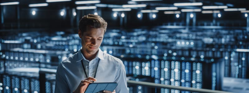 An engineer with a clipboard in a data centre